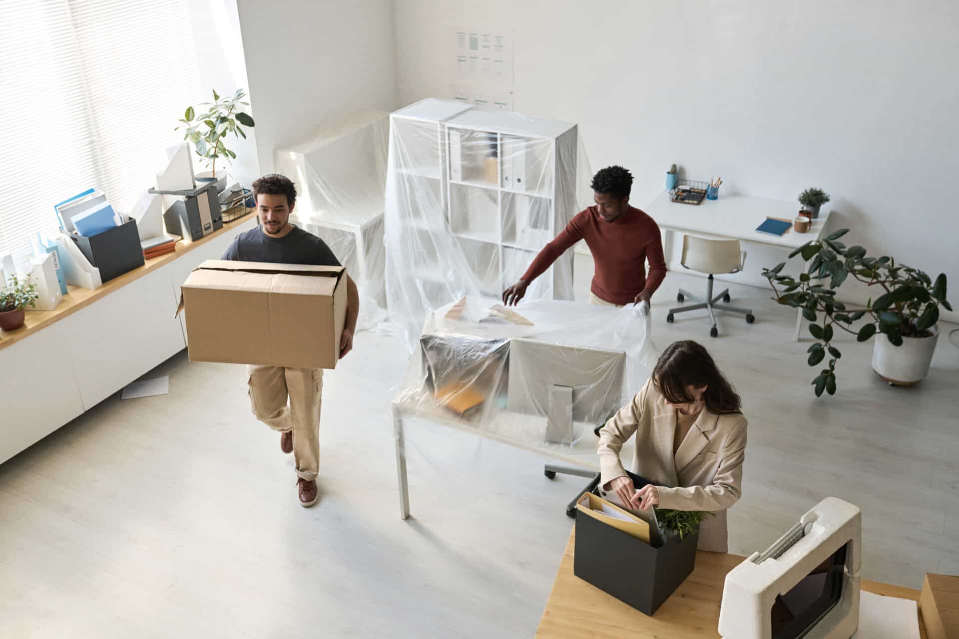 Business team packing furniture and boxes during an office move