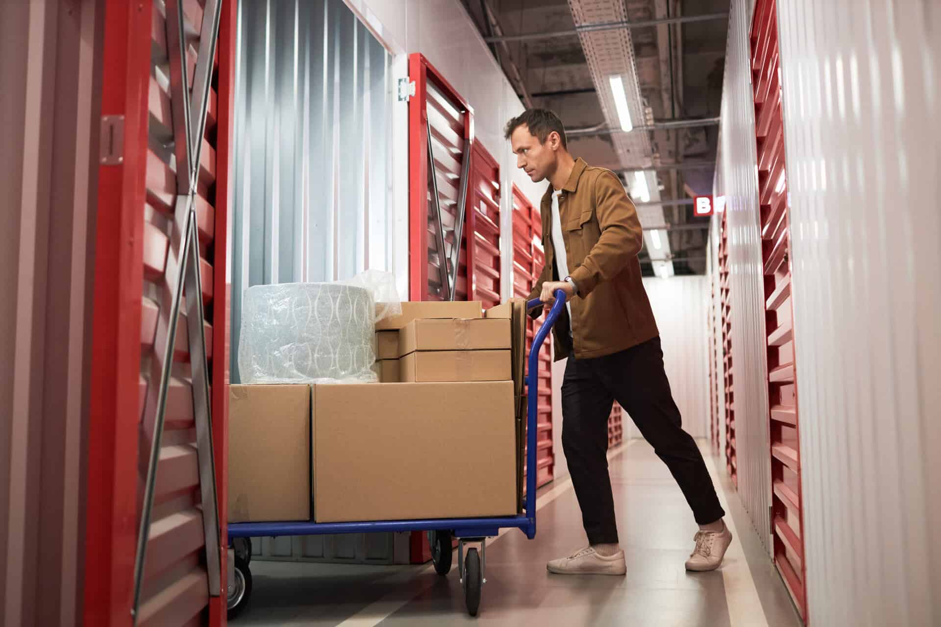 Customer moving boxes into a secure self-storage unit